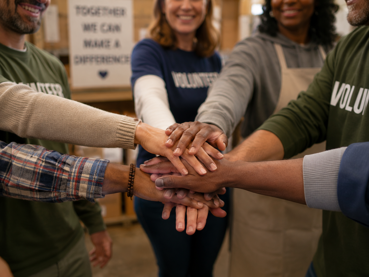 Hands joining together in a team circle